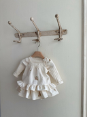 Aimee bloomer rokje van katoen in creme met geborduurde bloemen en elastische tailleband met verstelbare schouderbandjes met de Aimee top met embroidery bloemen en volants onderaan en topje eronder hangend vooraanzicht