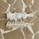 kanten Ivy haarbandje met bloemenmotiefje en zacht elastiek voor baby's en kinderen in de kleuren wit en creme liggend bovenaanzicht